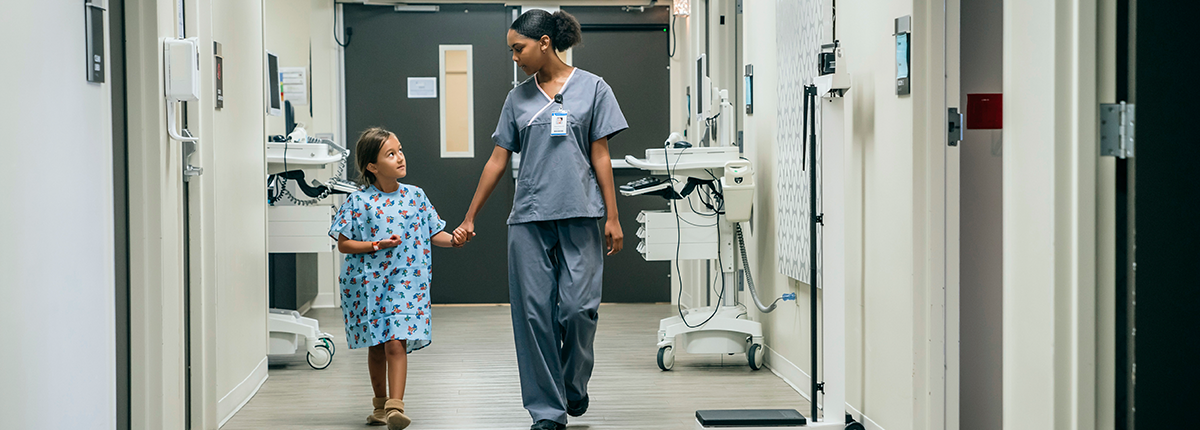 Nurse holding hands with a young patient